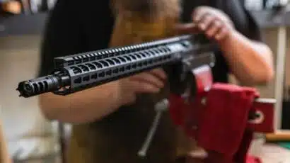 Close-up of an AR-15 rifle highlighting customization in a skilled maintenance environment.