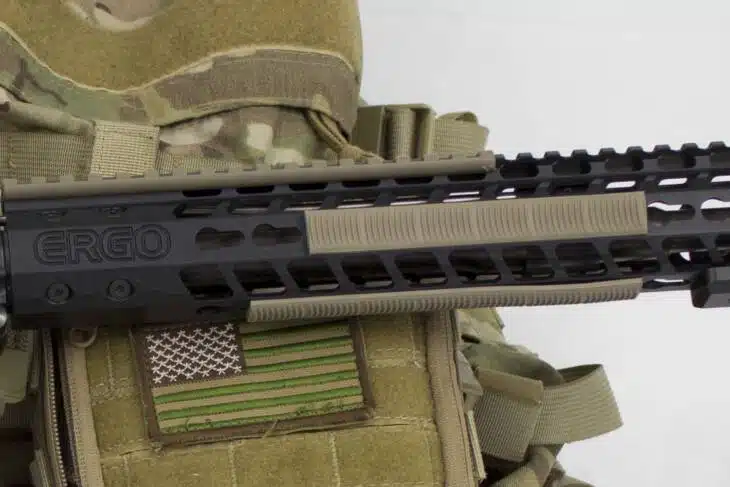 Tactical firearm setup with Ergo Keymod rail covers, enhancing grip and customization.