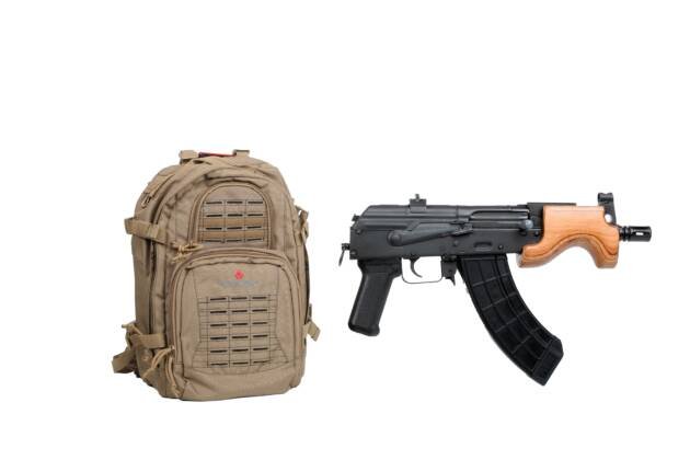 Tactical brown backpack and replica weapon for outdoor adventure, camping, and training.