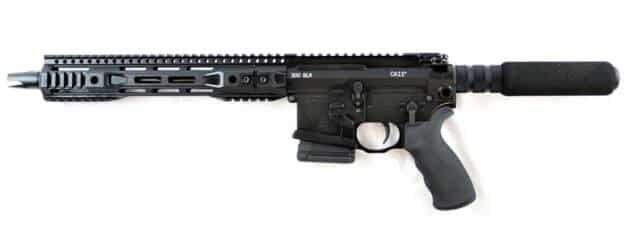 Tactical black rifle with rail system, suppressor, and adjustable stock for enhanced shooting performance.