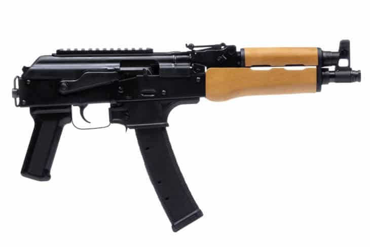 Sleek compact assault rifle with wooden stock, customization rails, and short barrel for optimal handling.