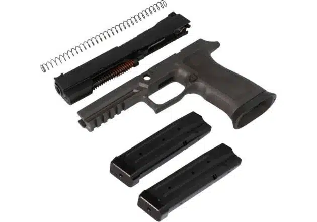 Disassembled semi-automatic handgun parts and magazines showcasing functional design and precision engineering.