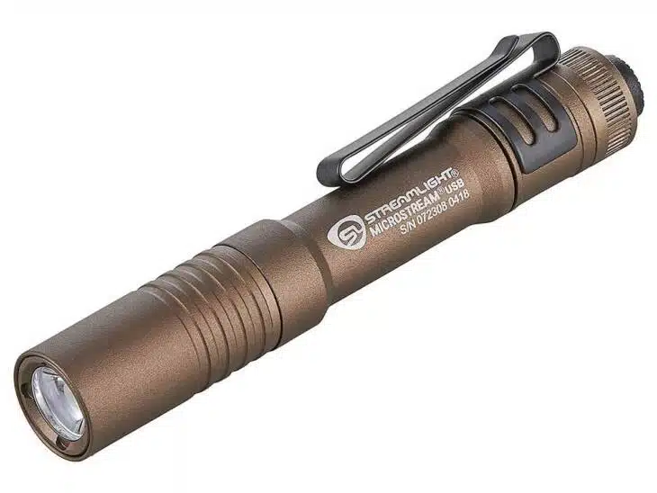 Rugged bronzed flashlight with pocket clip and adjustable brightness, ideal for outdoor adventures.
