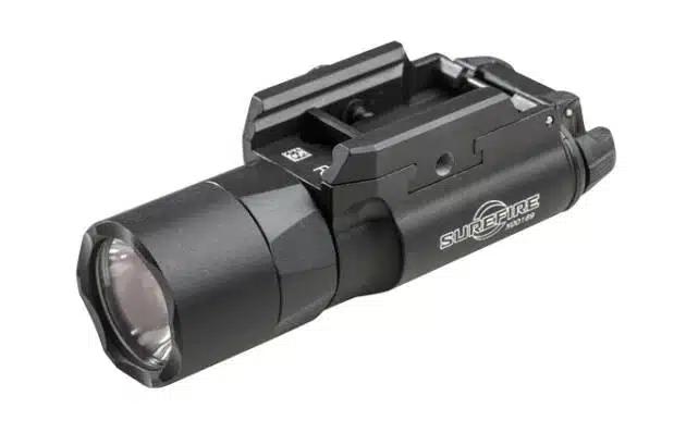 Durable LED tactical flashlight with textured grip and firearm mounting system for versatile use.