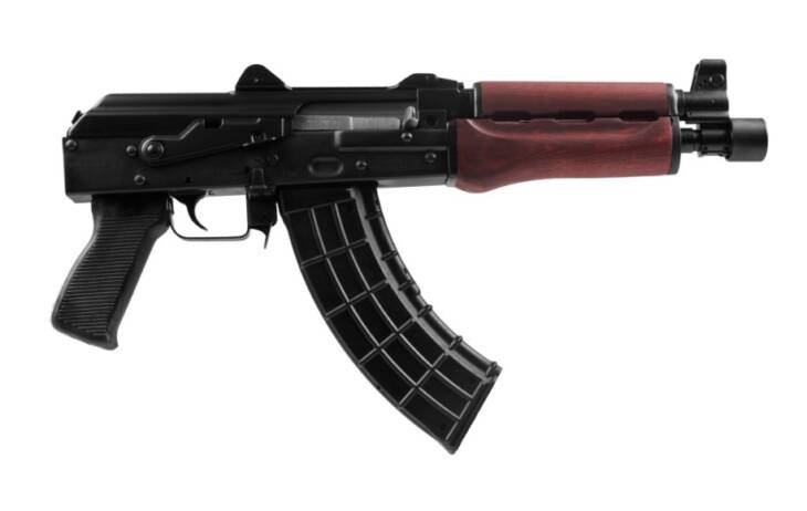 Robust AK Series firearm with high-capacity magazine, textured grip, and tactical rail for accessories.