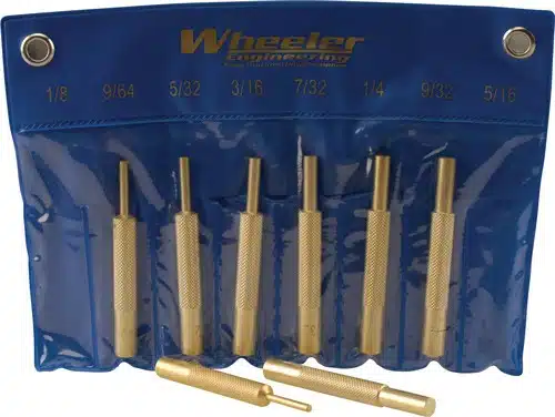 Organized brass punch set in blue holder for precise woodworking and metalworking tasks.